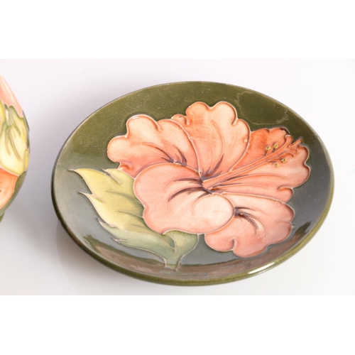 265 - Moorcroft Hibiscus vase, and a matching saucer.