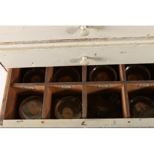 275 - Early 20th century painted specimen chest of drawers containing glass watch faces.