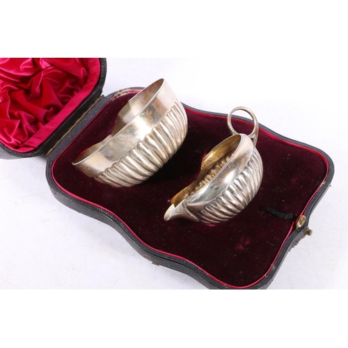 586 - Victorian silver creamer and matching sugar bowl of half lobed form, in original fitted retailers ca... 