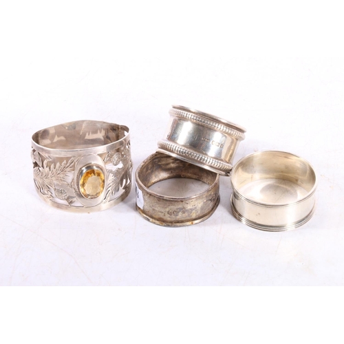 590 - Scottish style silver napkin ring set with central citrine coloured stone within pierced thistle dec... 