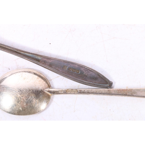 594 - Hallmarked silver spoons, 55g, together with two medical corps cap badges and officers pips