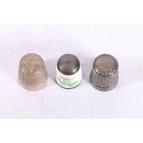 601 - Hallmarked silver thimble with hardstone top, Charles Horner Dorcas thimble and an enamel thimble wi... 