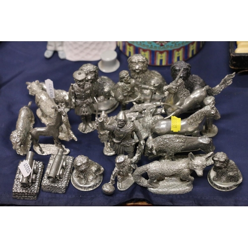 63 - Pewter animal and figural models to include Greyfriars Bobby, Mons Meg, a cannon, etc.