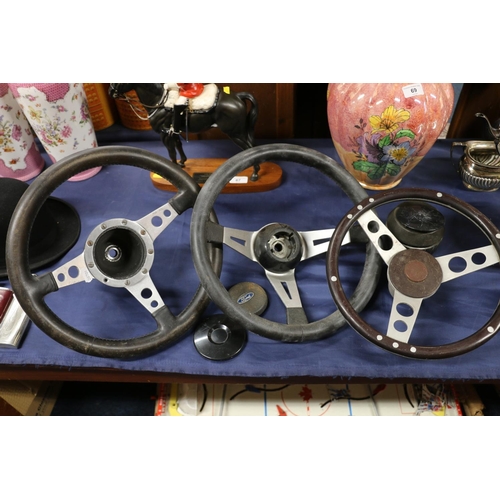 68 - Three vintage steering wheels.