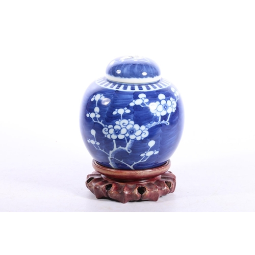 78 - Chinese ginger jar decorated with prunus on hardwood base, 18cm high including base.