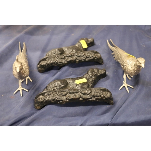 87 - Two fireside cast iron dogs and silver-plated pheasant models.