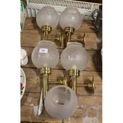 197 - Four brass wall lamps with glass shades and lawn bowls.