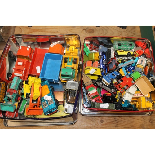 206 - Two tins containing playworn die-cast vehicles.