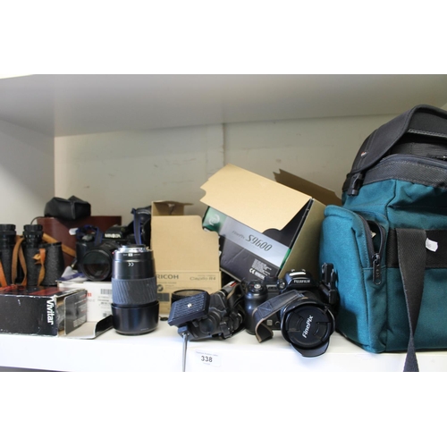 338 - Shelf containing cameras and camera equipment to include a Minolta camera, lenses, cased binoculars,... 