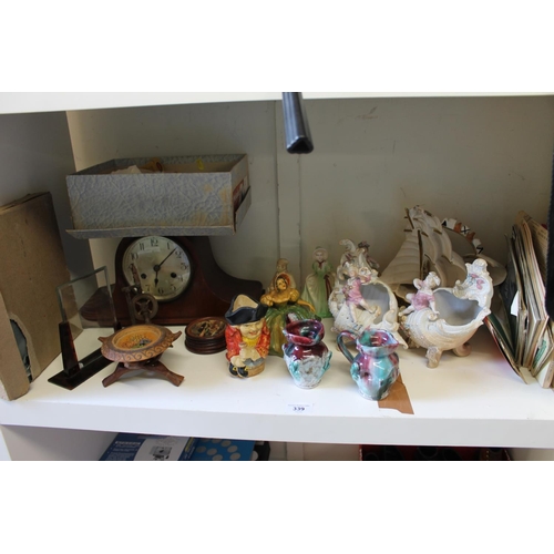 339 - Porcelain figures, a mantel clock, first aid items, etc.