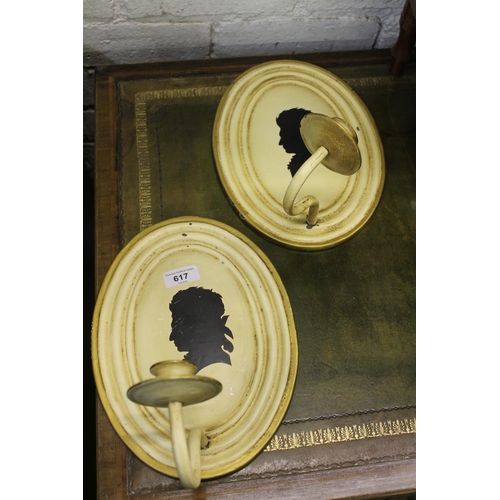 617 - Pair of 20th century painted metal candle sconces with silhouette portrait decoration.