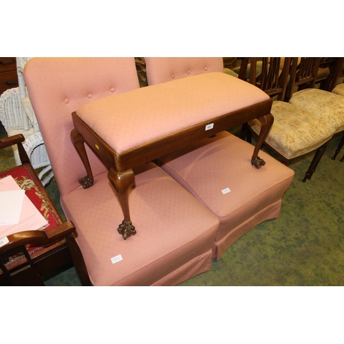 654 - Pair of pink upholstered low chairs and a matching stool, raised on claw and ball feet.