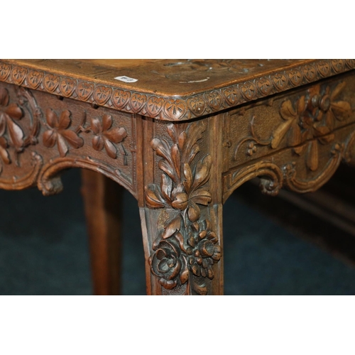 669 - Early 20th century games table with undertier drawers and shelves, heavily carved with foliage, 76cm... 