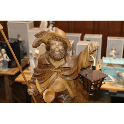 684 - Swiss/German carved wooden figure of a nightwatchman holding halberd and lamp.