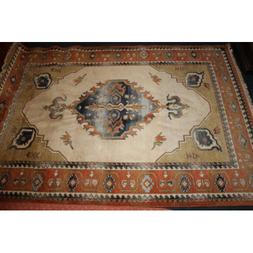 704 - Caucasian rug on cream and rust red ground, 195cm x 280cm.