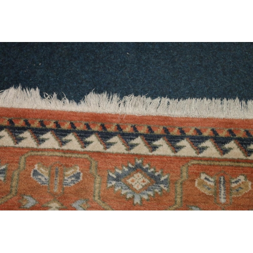 704 - Caucasian rug on cream and rust red ground, 195cm x 280cm.