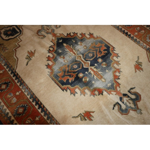 704 - Caucasian rug on cream and rust red ground, 195cm x 280cm.