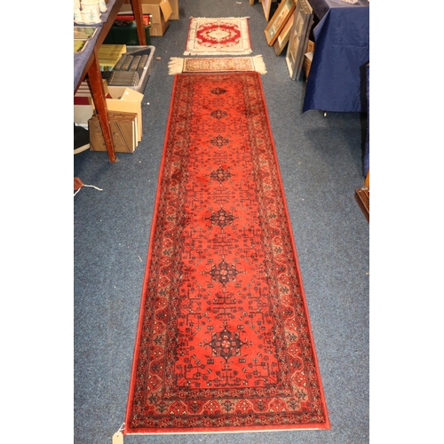 705 - Topkapi carpet, another small rug, and a rust red Persian runner, 275cm x 69cm.