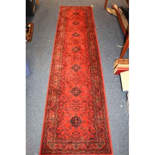 705 - Topkapi carpet, another small rug, and a rust red Persian runner, 275cm x 69cm.