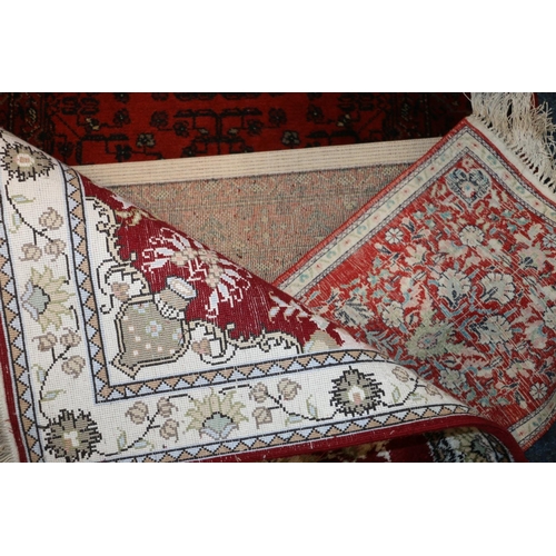 705 - Topkapi carpet, another small rug, and a rust red Persian runner, 275cm x 69cm.