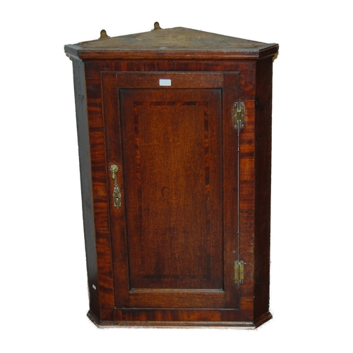 433 - 18th century George III oak corner cupboard, the hinged door enclosing later painted shelving, brass... 