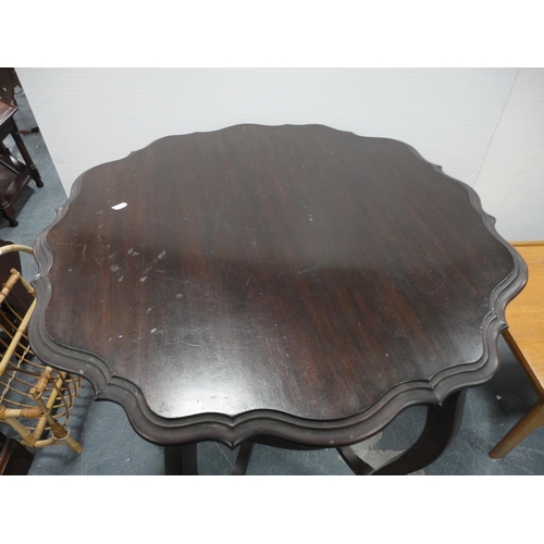 322 - Teak coffee table and a mahogany piecrust-edge window table.  (2)