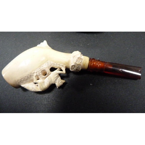 236 - Group of meerschaum pipes and cheroot holders to include a silver-mounted cheroot holder, all in fit... 