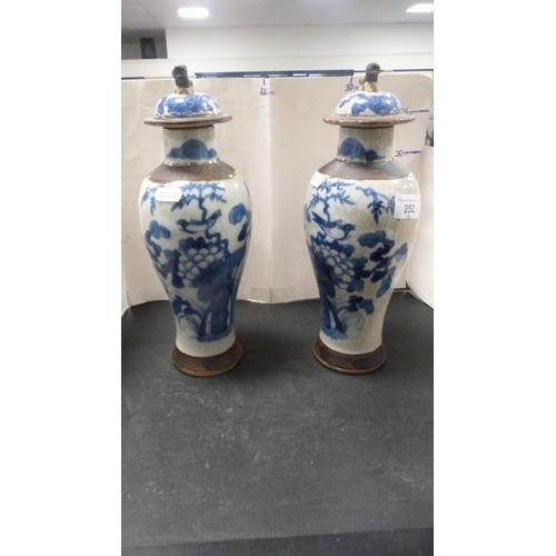 252 - Pair of Chinese blue and white crackle glaze baluster vases with covers and oxidised bands.