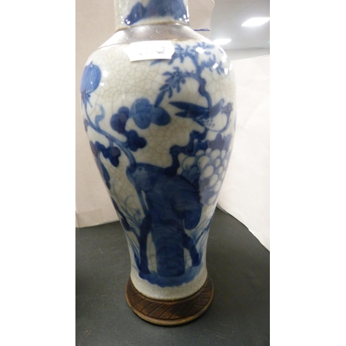 252 - Pair of Chinese blue and white crackle glaze baluster vases with covers and oxidised bands.