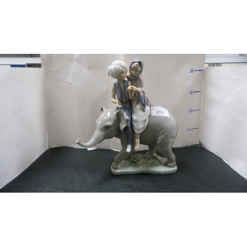 255 - Lladro figure group modelled as two Eastern children riding an elephant.