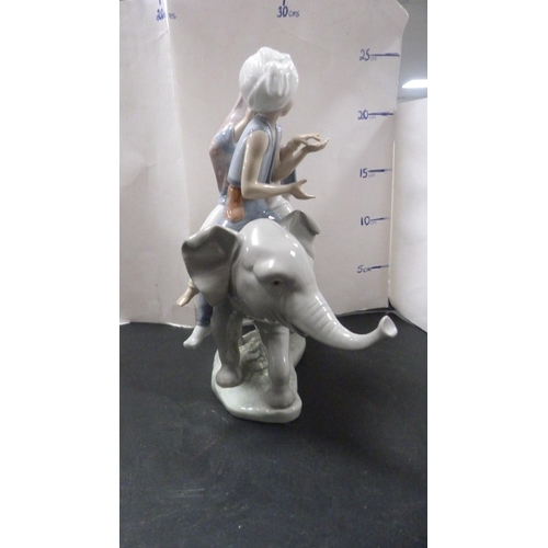 255 - Lladro figure group modelled as two Eastern children riding an elephant.