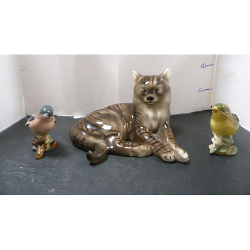 260 - Two small Beswick bird figures of a chaffinch and greenfinch, and a porcelain figure of a cat by Roy... 