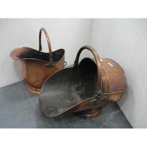 318 - Two copper coal helmets.