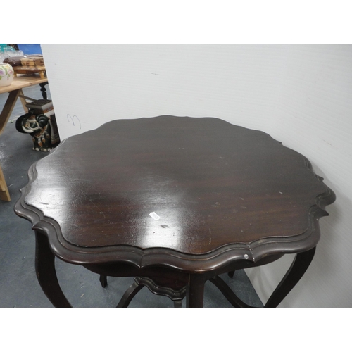 322 - Teak coffee table and a mahogany piecrust-edge window table.  (2)