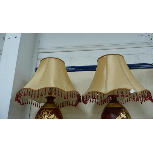 56 - Pair of impressive pottery gilt decorated table lamps with shades.  (2)