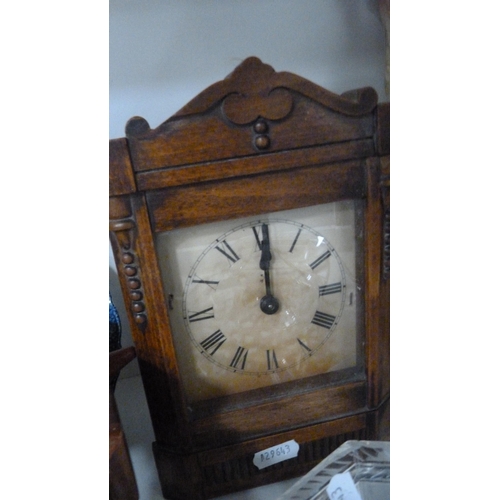 77 - Two clocks, EP cake baskets, EP tea caddy, jug etc (one shelf).