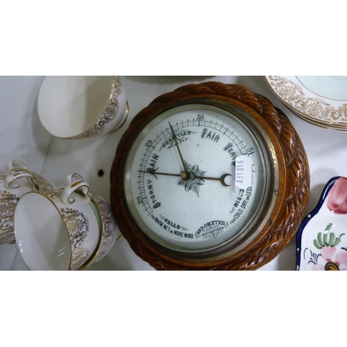 89 - Carved oak barometer, three Hummel figures, Royal Tron part tea set etc (one shelf).