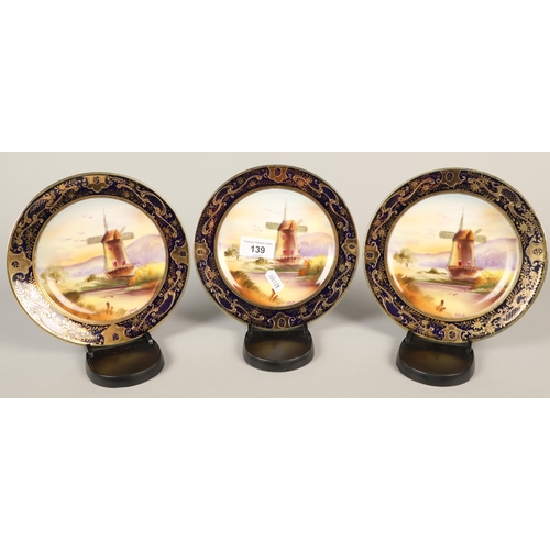 139 - Three Noritake plates decorated with windmills 18cm