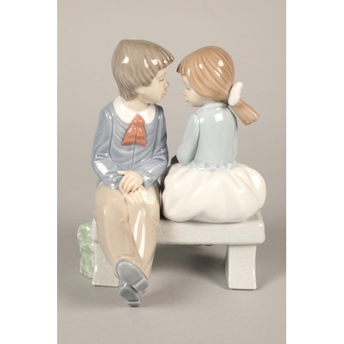 145 - Nao figure of a boy and girl seated on a bench