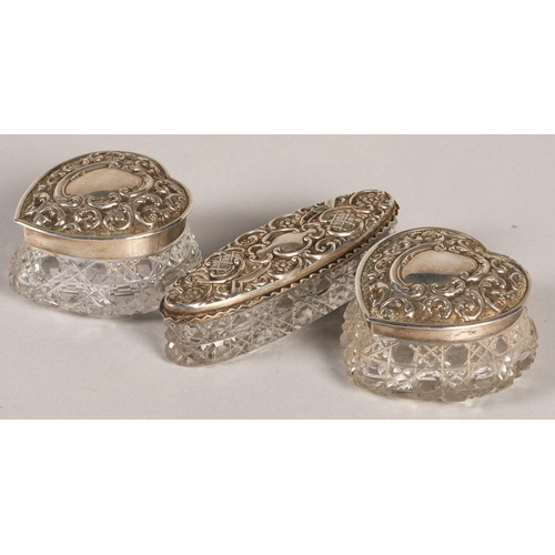 163 - A pair of silver topped heart shaped trinket boxes and also another silver topped pin box.