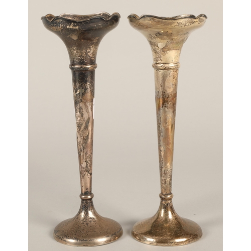 171 - A pair of silver rose vases, loaded bases 22cm high