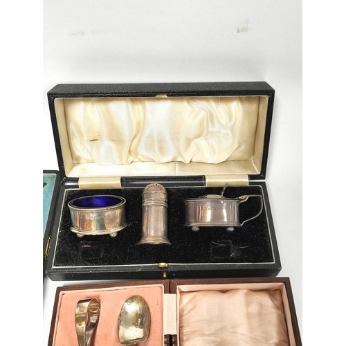 13 - Silver three piece condiment set, plain oval, Birmingham 1935 and a spoon and pusher, both cased.