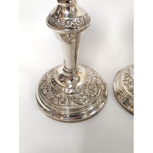 2 - Pair of silver table candlesticks with knopped stems and embossed bands. 19cm. Mid 20th century.