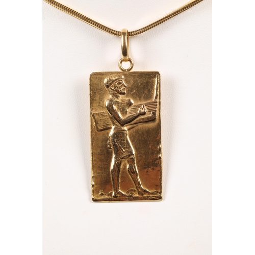 114 - 18ct gold Egyptian pendent with a 18ct gold chain, stamped 750, 33 grams