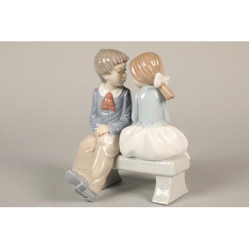 145 - Nao figure of a boy and girl seated on a bench