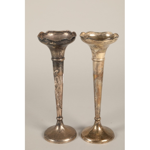 171 - A pair of silver rose vases, loaded bases 22cm high