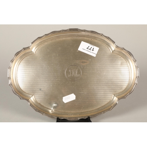 177 - Silver engine turned shaped oval card tray with central monogram 25cm diameter 283 grams