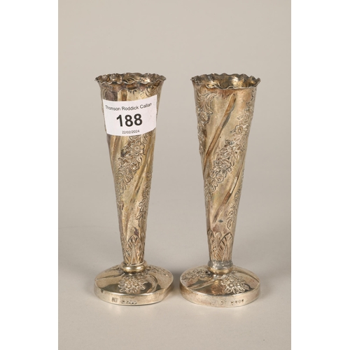 188 - Pair of silver floral decorated rose vases 13cm high and also a silver mounted wine coaster.