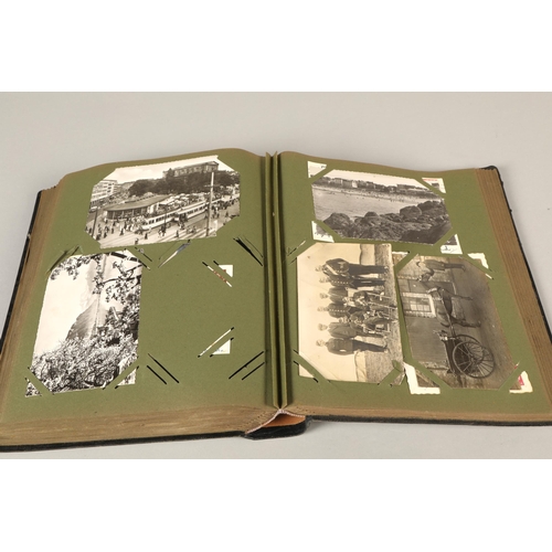 212 - A postcard album containing war related cards, topographical etc