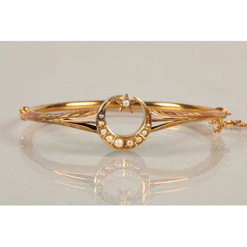 78 - 9 ct gold bangle with moon and star , with seed pearls, 5.6 grams total weight